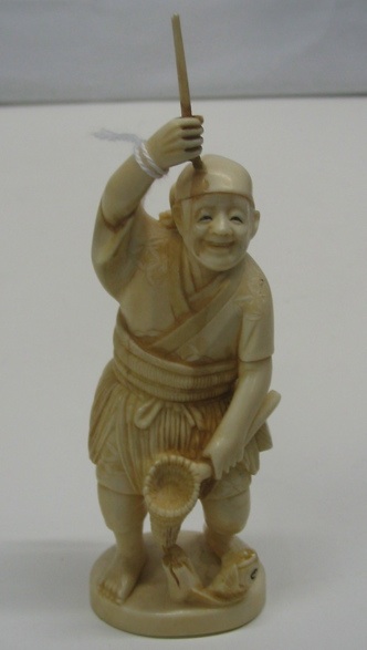 Appraisal: A JAPANESE CARVED IVORY OKIMONO figure of fisherman holding pole