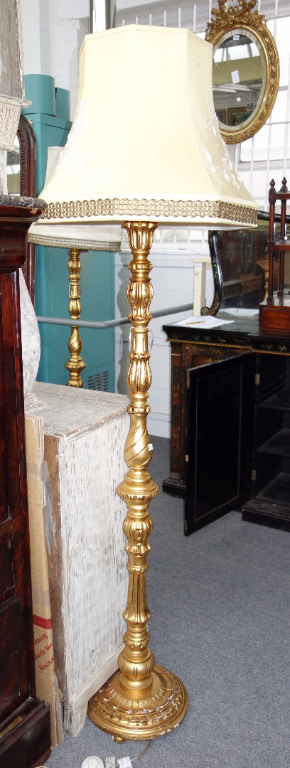 Appraisal: A pair of Georgian style giltwood standard lamps modern with