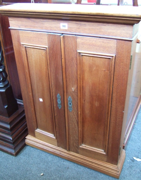 Appraisal: An oak small two door cabinet with fielded panels cm