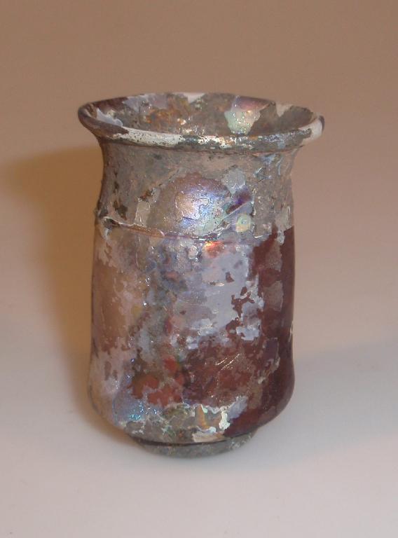 Appraisal: A small Roman pale purple glass beaker with a thickened