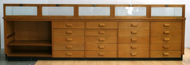 Appraisal: A large th century multi-drawer shop display cabinet with glass