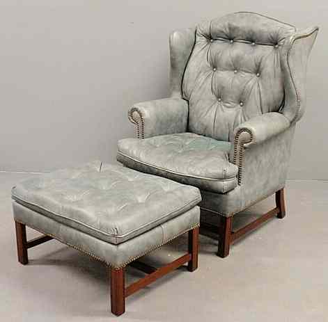 Appraisal: Chippendale style blue leather wing chair and matching footstool by