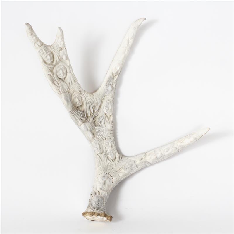 Appraisal: Native American deer antler carving featuring native faces and spirit