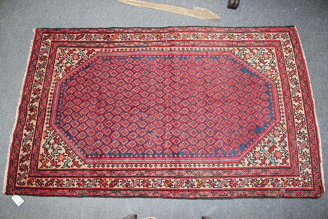 Appraisal: A BLUE GROUND ARAK RUG the dense foliate field within