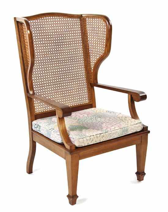 Appraisal: An American Caned Open Armchair having a curved crest above