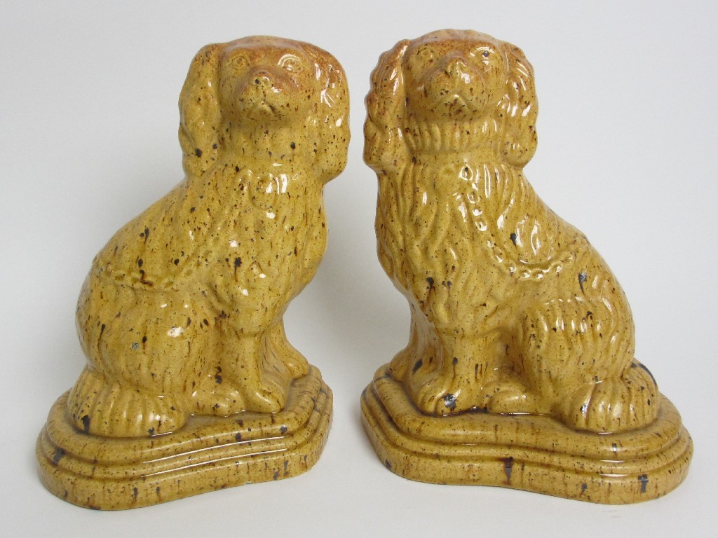 Appraisal: A pair of stoneware models of Spaniels with speckled glaze