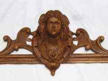 Appraisal: A carved walnut pediment probably French of a woman's garlanded