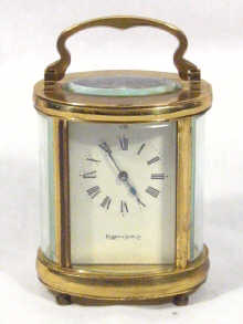 Appraisal: An oval brass carriage clock the white dial marked 'Mappin