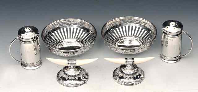 Appraisal: A PAIR OF SILVER PEPPERS with press on lids and