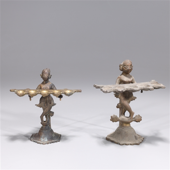 Appraisal: Pair of antique Indian bronze oil lamps each with figures