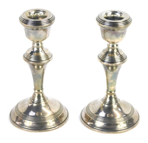 Appraisal: A pair of Elizabeth II loaded silver candlesticks Birmingham oz