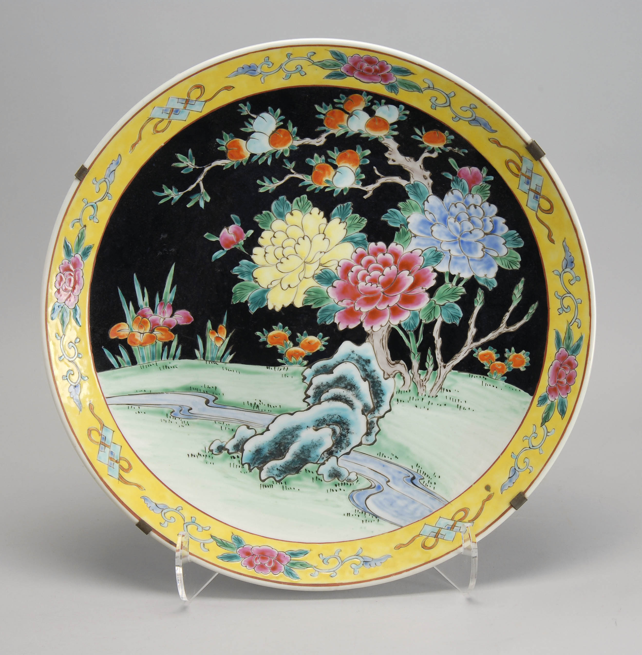 Appraisal: POLYCHROME PORCELAIN CHARGER Circa With peony peach and iris design