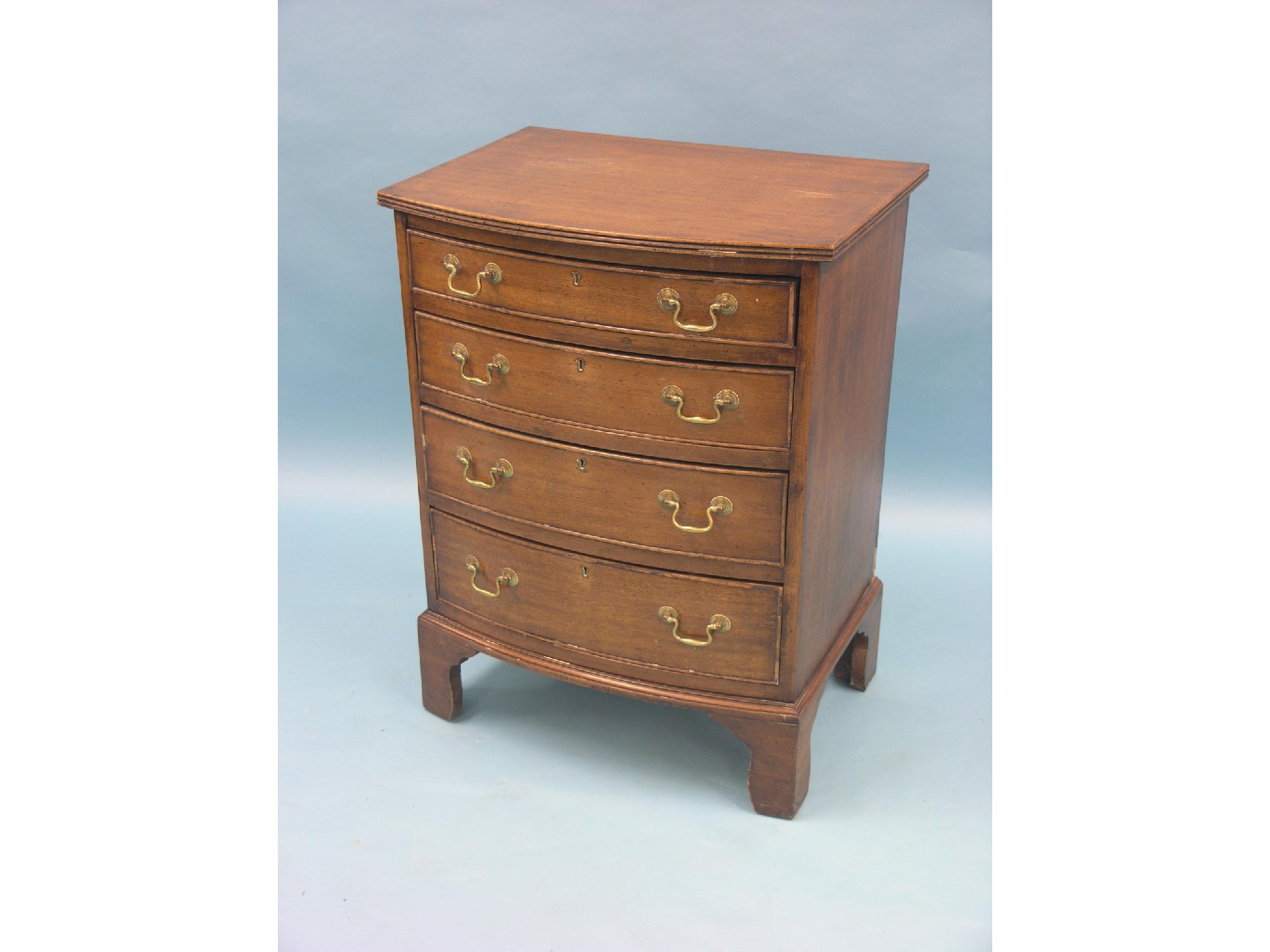 Appraisal: A Georgian-style mahogany bow-front chest four graduated drawers with brass