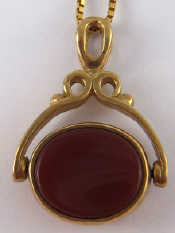 Appraisal: A carat gold swivel seal pendant on a yellow metal