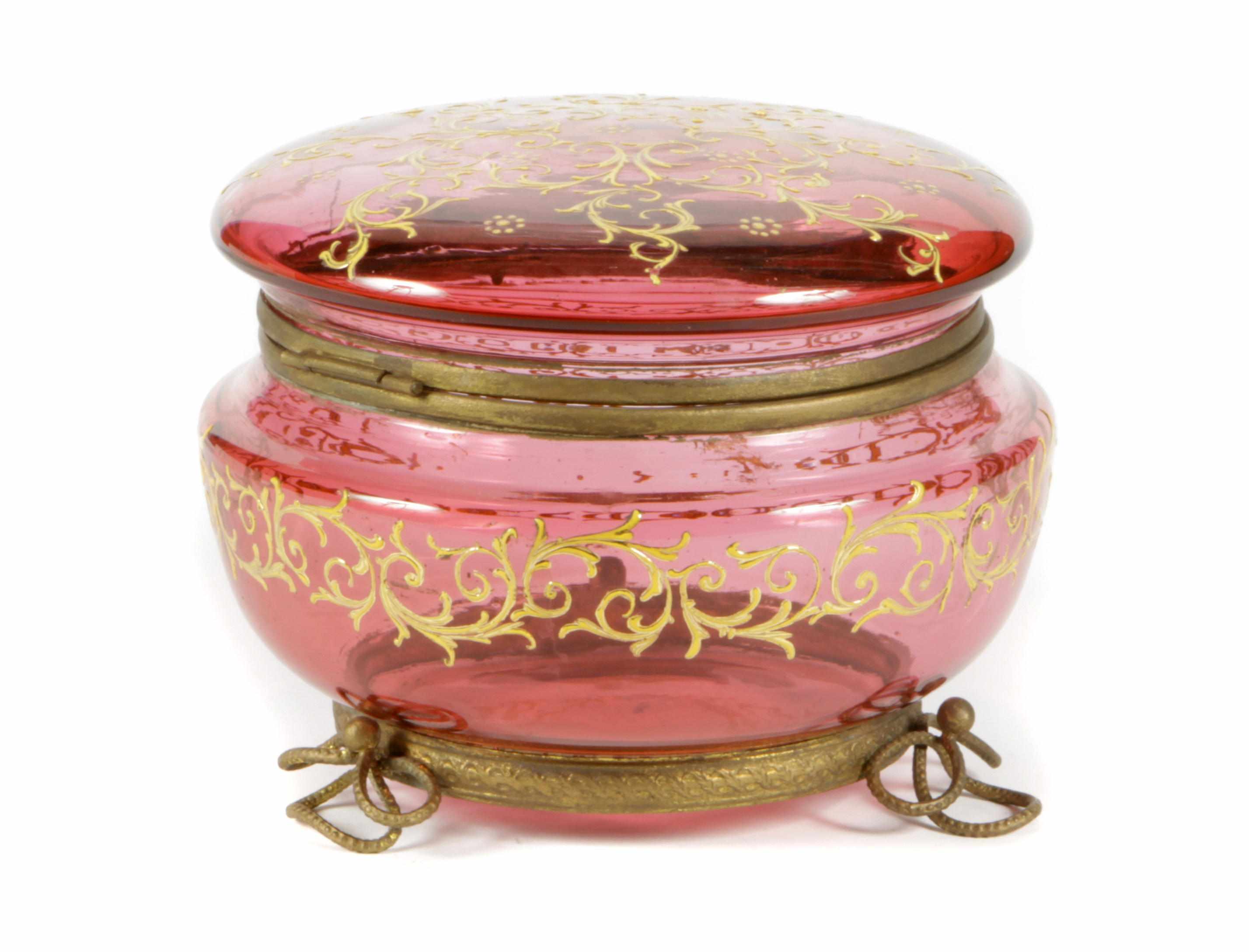 Appraisal: A Continental gilt heightened cranberry glass circular covered box On