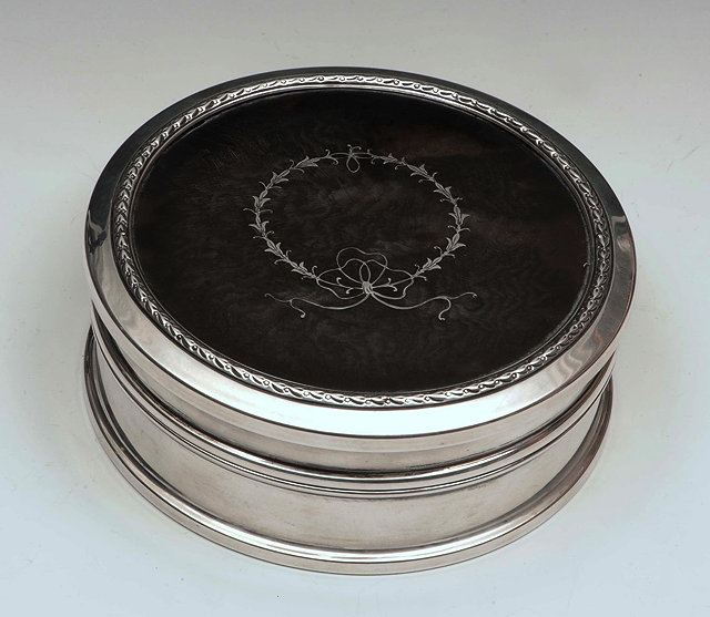 Appraisal: A SILVER AND TORTOISESHELL CIRCULAR BOX the cover with piqu