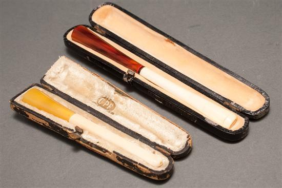 Appraisal: Two Art Deco ivory and celluloid cigarette holders in fitted