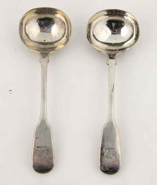 Appraisal: A pair of William IV silver fiddle pattern sauce ladles