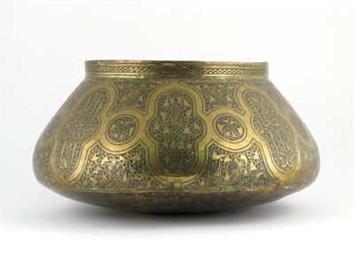 Appraisal: A large Middle Eastern brass bowl engraved with calligraphy and