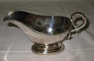 Appraisal: A SAUCE BOAT of oval form with gadrooned rim and