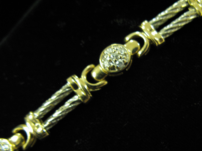 Appraisal: DIAMOND AND FOURTEEN KARAT WHITE AND YELLOW GOLD BRACELET The