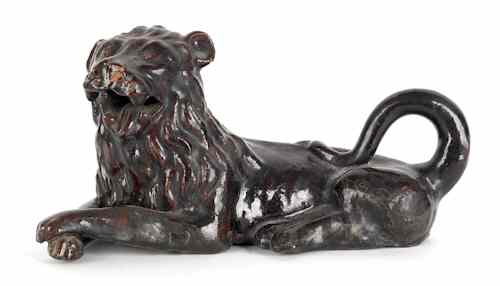 Appraisal: Earthenware figure of a recumbent lion th c h together