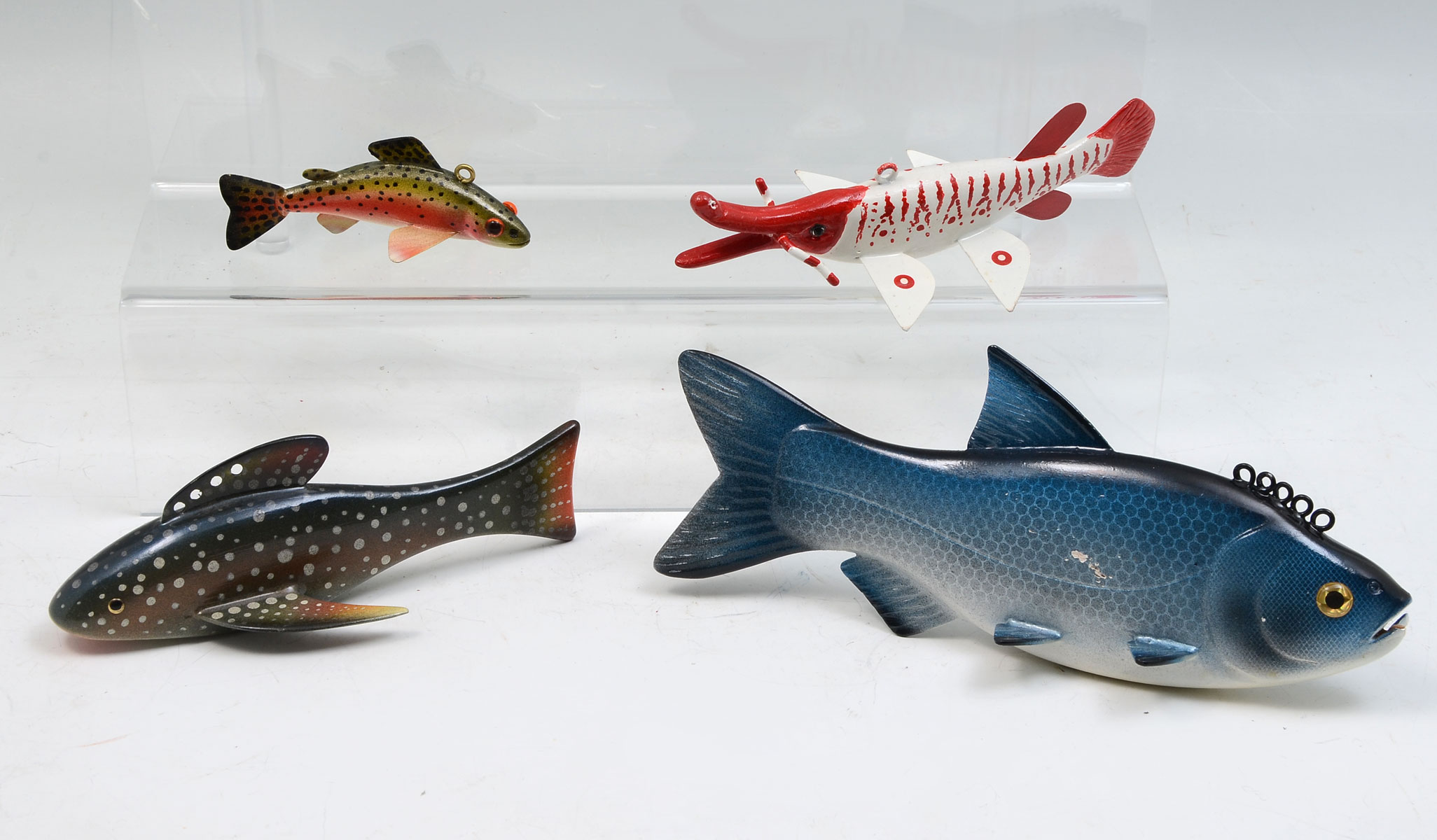 Appraisal: FOUR PAUL MCNEAL HAND CARVED AND PAINTED FISH DECOYS Four