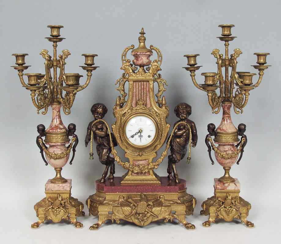 Appraisal: IMPERIAL FIGURAL CLOCK GARNITURE SET Figural pan children cast metal