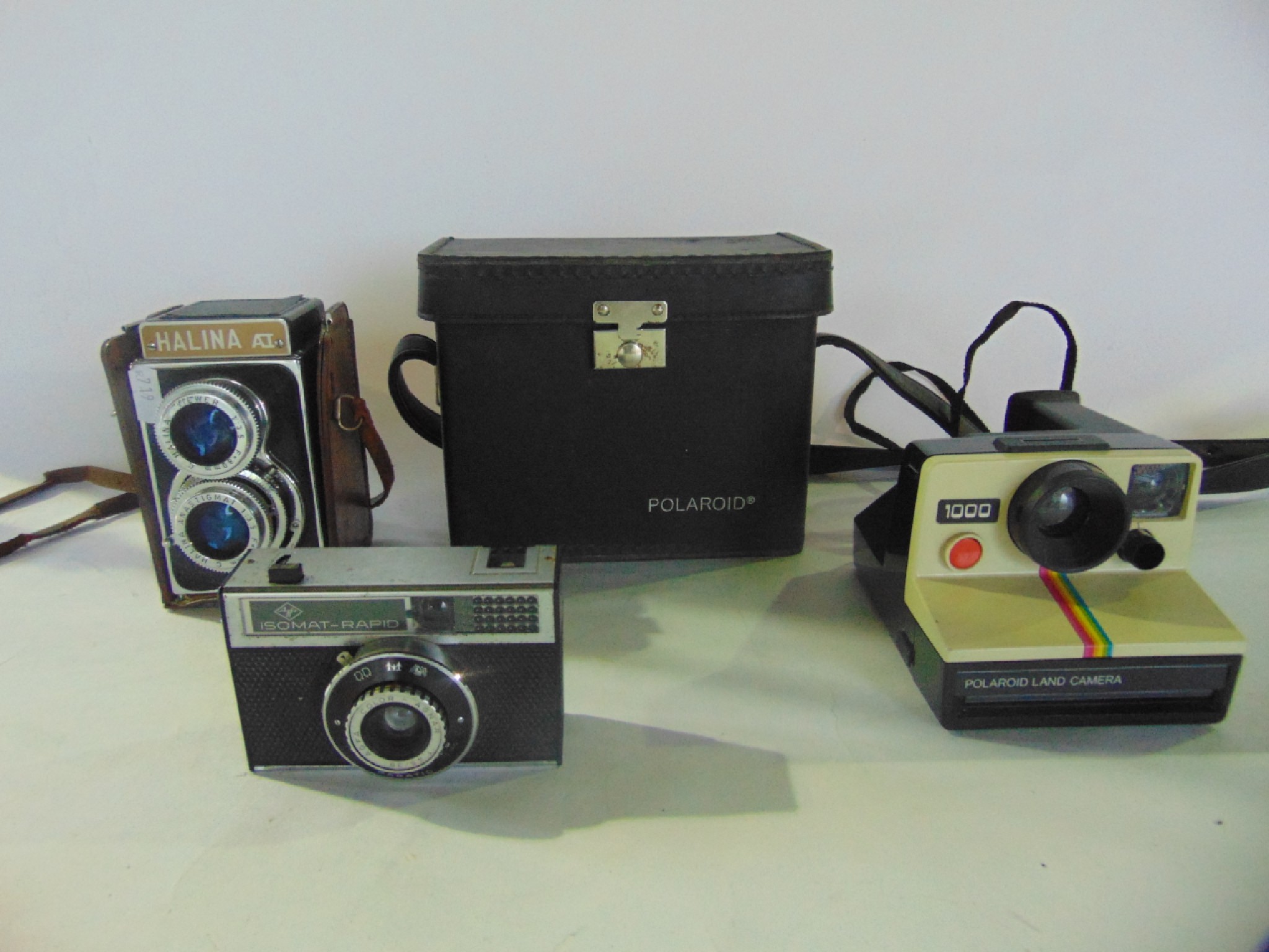 Appraisal: A cased polaroid land camera model together with a Halina