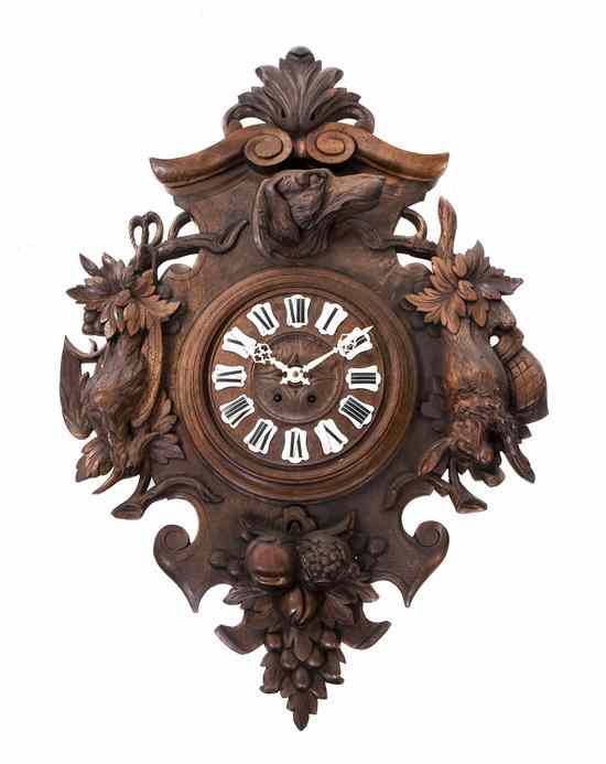 Appraisal: A Black Forest Style Carved Wall Clock the segmented enameled