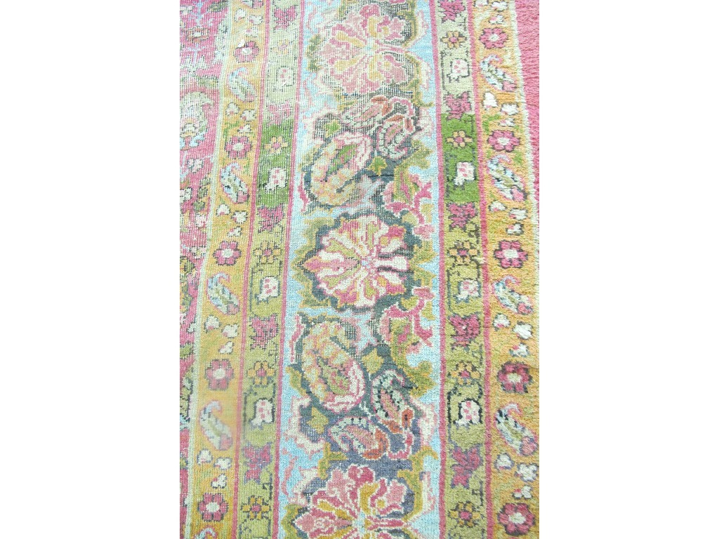 Appraisal: A large Eastern carpet decorated with a floral border and