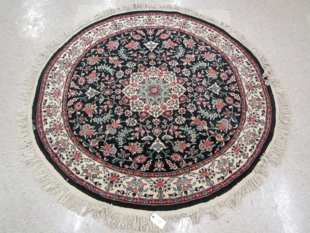 Appraisal: A ROUND ORIENTAL AREA RUG Indo-Persian floral and central floral