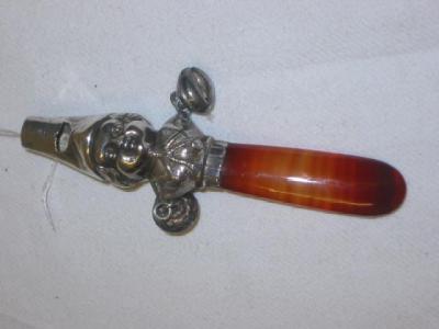 Appraisal: A BABY'S VICTORIAN RATTLE modelled as a child's head with