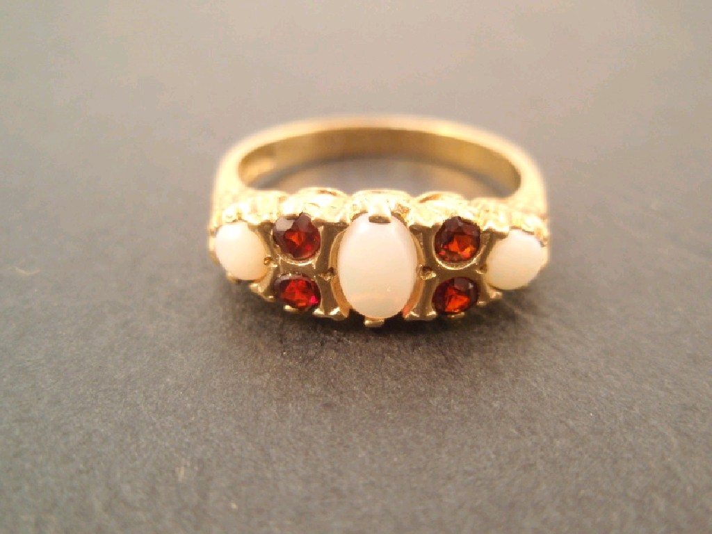 Appraisal: A ct gold dress ring set with opals and garnets