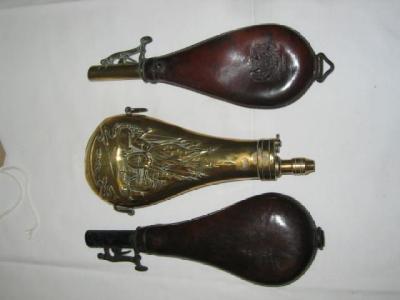 Appraisal: A BRASS POWDER FLASK with spring loaded nozzle feed embossed