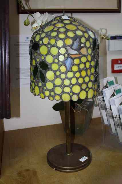 Appraisal: A TIFFANY STYLE COLOURED GLASS AND LEADED LAMP on metal