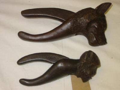 Appraisal: A PAIR OF BLACK FOREST CARVED WOOD NUT CRACKERS modelled