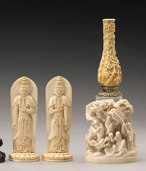 Appraisal: Four carved ivory decorations Including a pair of standing Buddhist