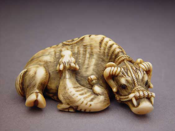 Appraisal: ANTIQUE IVORY NETSUKE Finely carved and antique ivory netsuke of