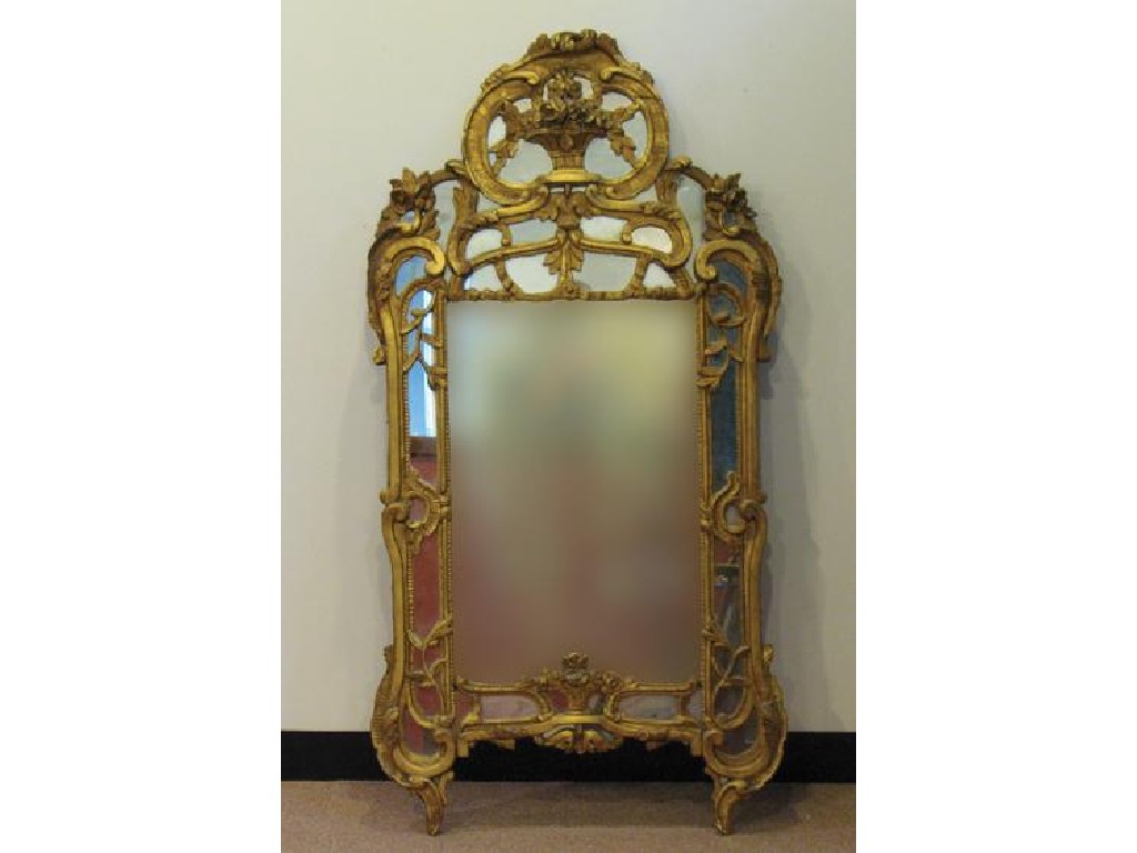 Appraisal: A CONTINENTAL GILTWOOD WALL MIRROR the central rectangular plate within