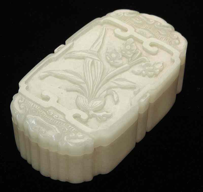 Appraisal: Chinese Qing carved jade box depictingdaffodil blossoms ''H x ''W