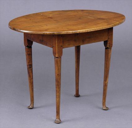 Appraisal: NEW ENGLAND FIGURED MAPLE TEA TABLE The oval overhang top