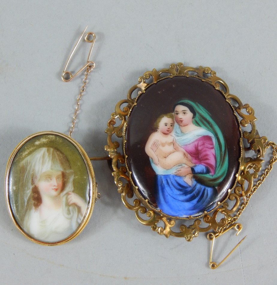 Appraisal: Two painted enamel brooches each depicting a female one with