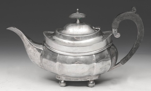 Appraisal: A SILVER TEAPOT of shaped baluster form on bun supports