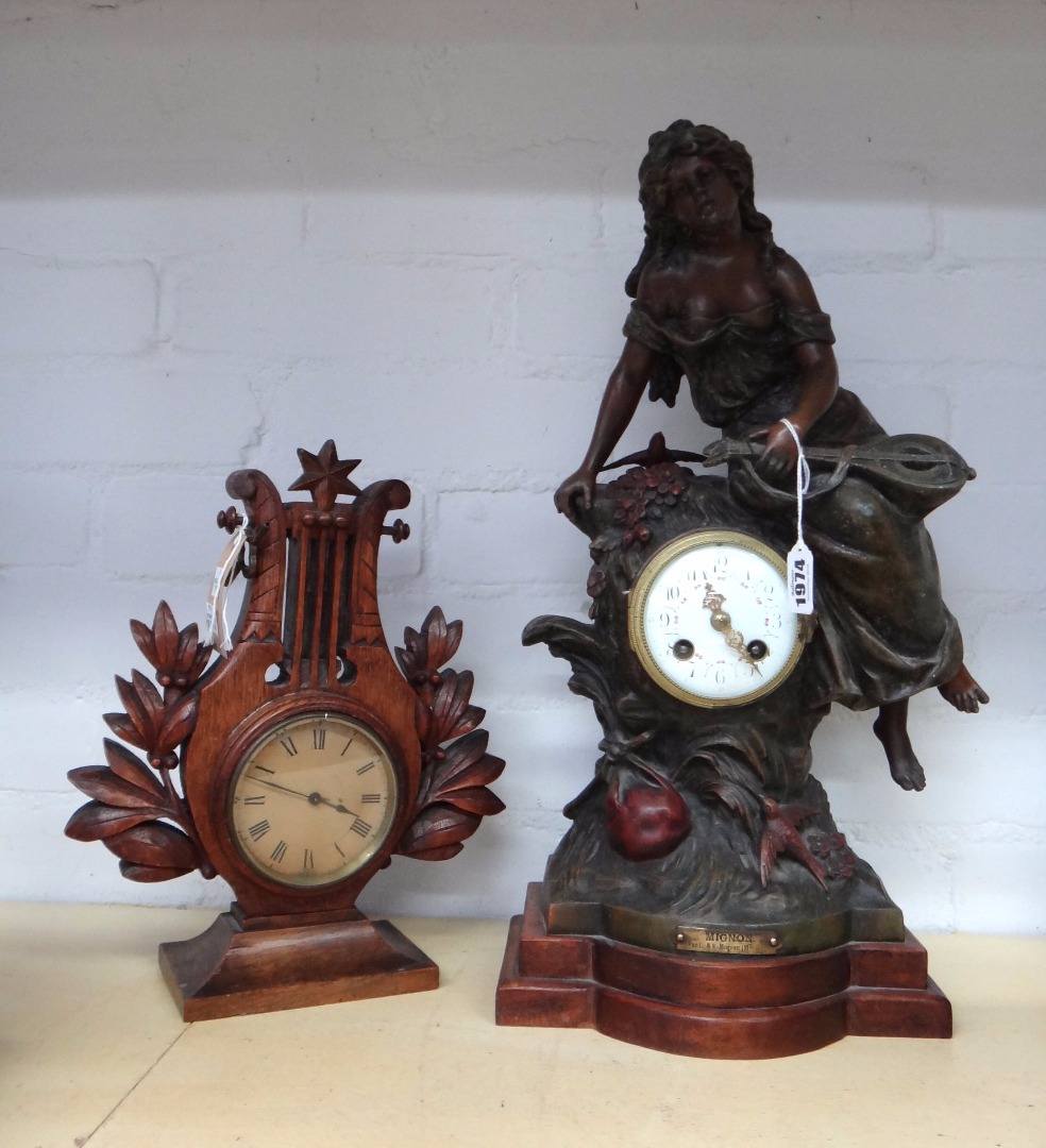 Appraisal: A patinated spelter mantel clock early th century surmounted with