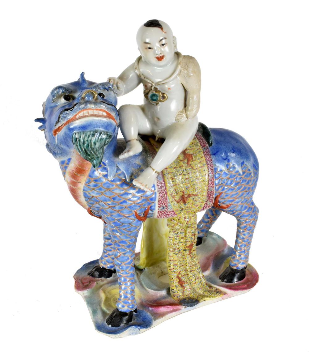 Appraisal: CHINESE GLAZED PORCELAIN BOY ATOP A CHIMERA th Century Colorfully