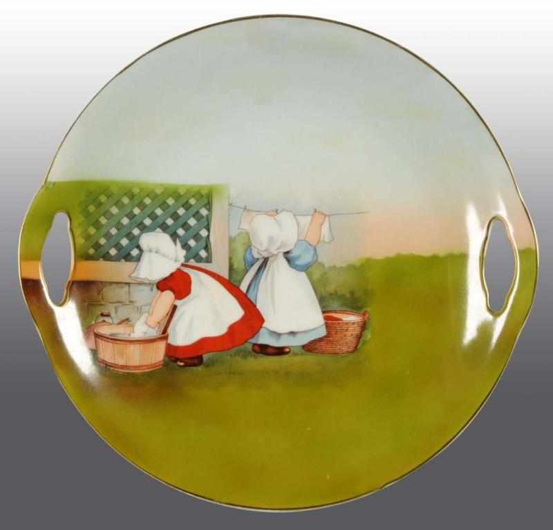 Appraisal: Royal Bayreuth Sunbonnet Babies Open Handle Plate Description Hanging clothes