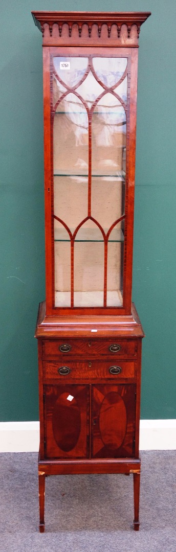 Appraisal: A George III style narrow satinwood single door display cabinet