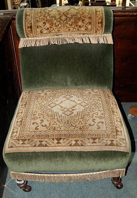 Appraisal: Victorian carpet upholstered low armchairwith turned supports