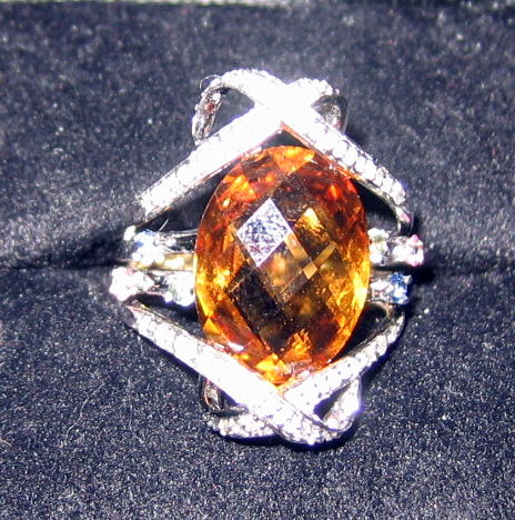 Appraisal: CITRINE AND DIAMOND RING With checkerboard faceted oval citrine approximately